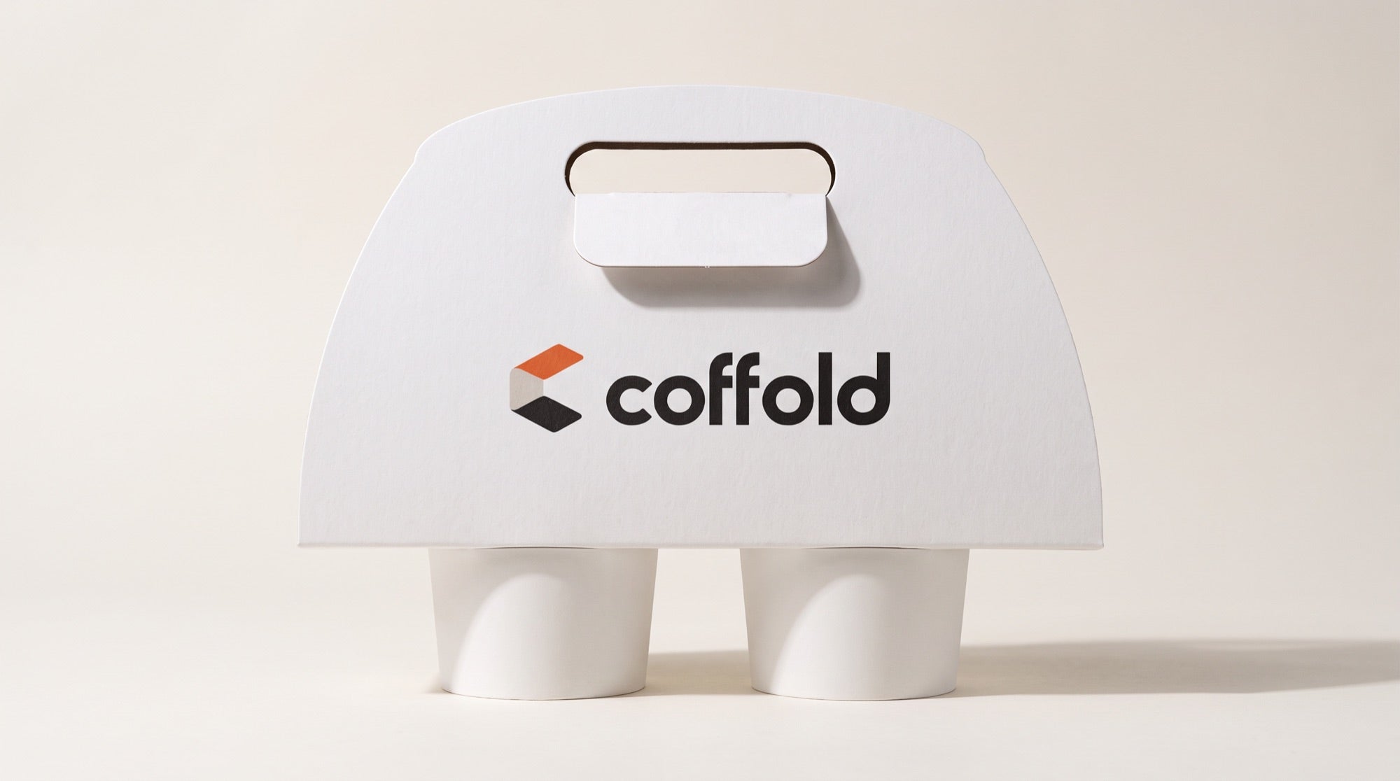 Front view of the Coffold folding two-cup carrier in 350 gsm white board, tab locked through the handle slot